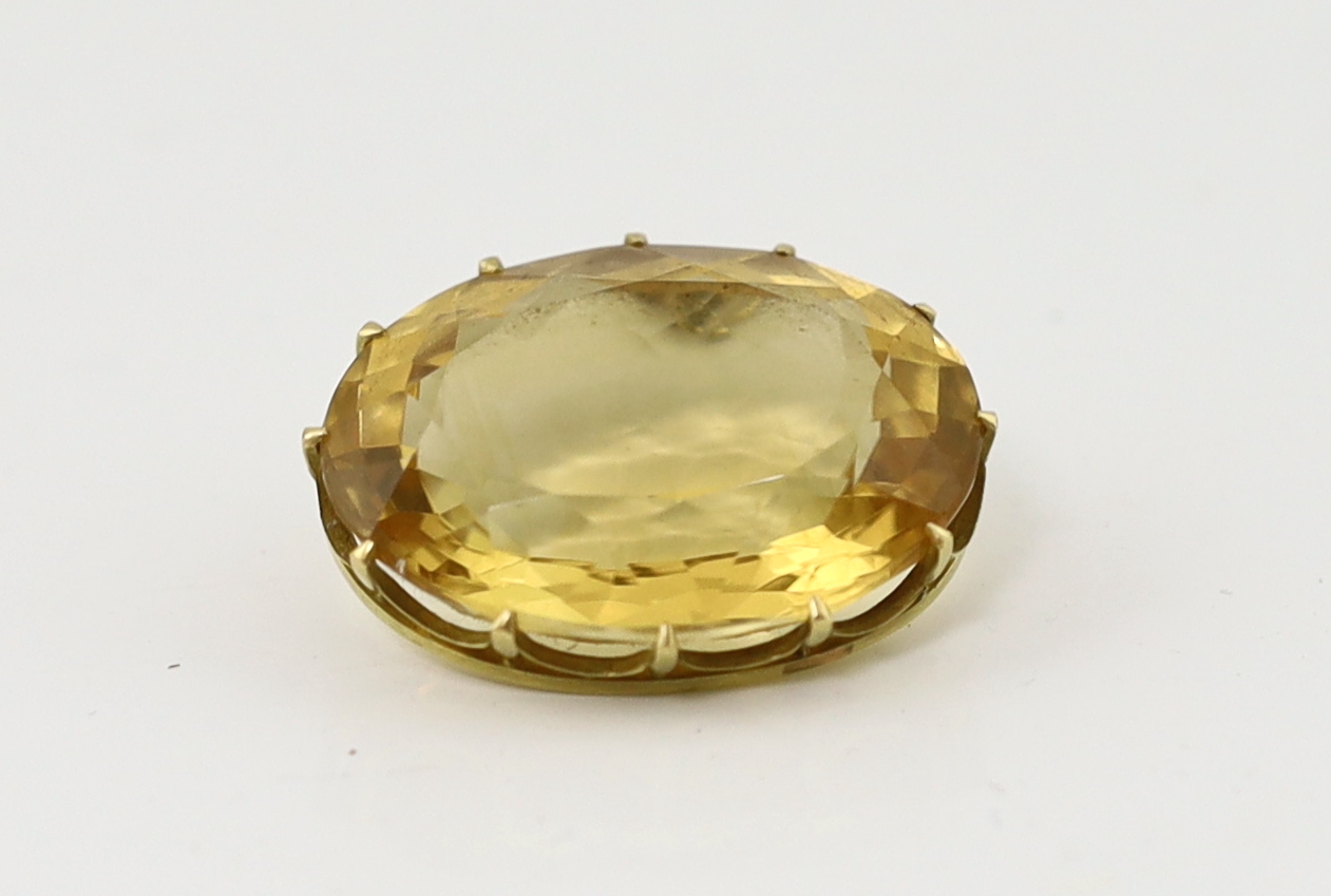 A large gold mounted oval cut citrine set pendant